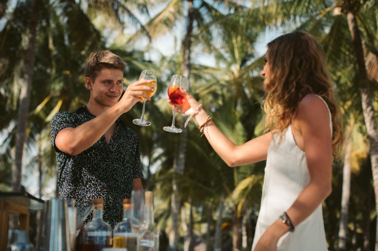 Oceanica Resort Panglao, Bohol Eksteriør billede Two people toasting with wine